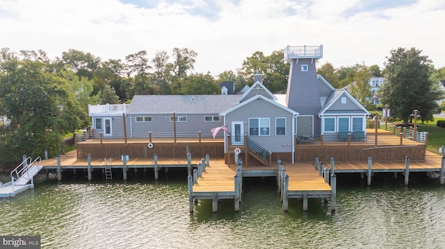 back of property with a deck with water view