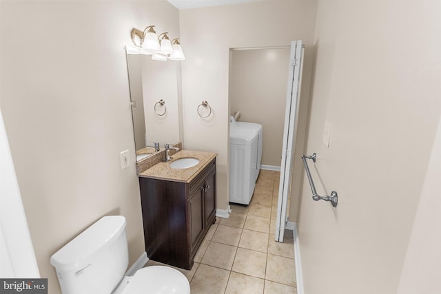 bathroom with washer and dryer, tile patterned floors, vanity, and toilet