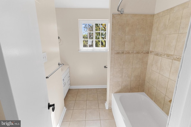 bathroom featuring tile patterned flooring and tiled shower / bath