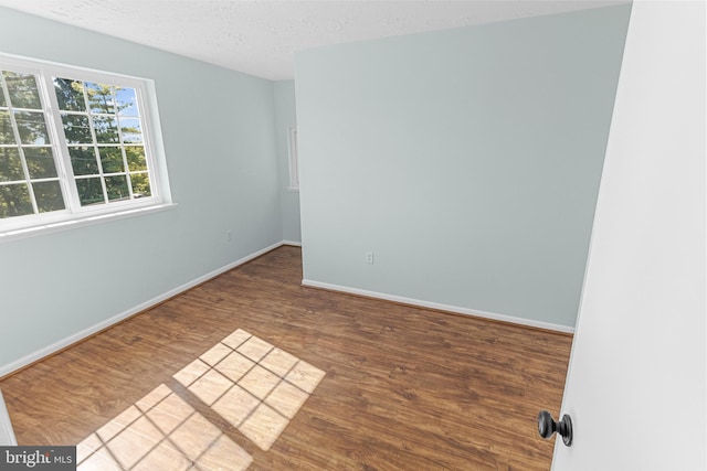 empty room featuring hardwood / wood-style floors and a textured ceiling