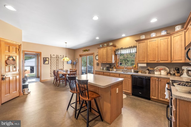 kitchen featuring gas stove, black dishwasher, hanging light fixtures, sink, and a center island