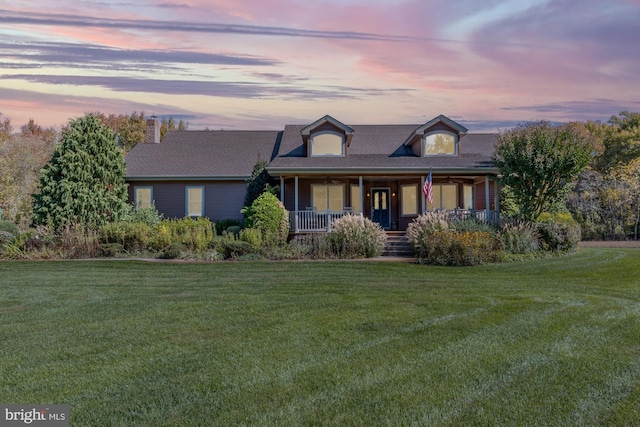 view of front of house with a yard and covered porch