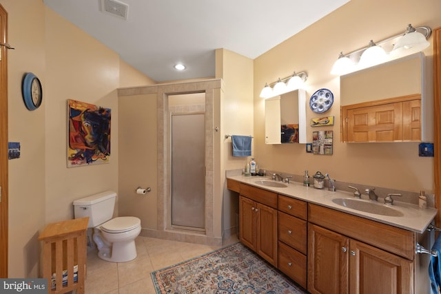 bathroom featuring toilet, an enclosed shower, vanity, and tile patterned floors