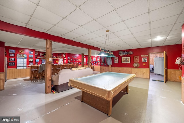 game room featuring pool table, concrete flooring, and a paneled ceiling