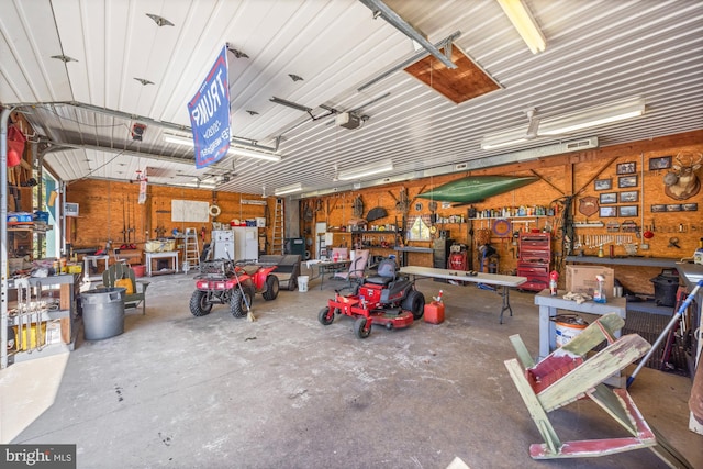 garage with a garage door opener and a workshop area