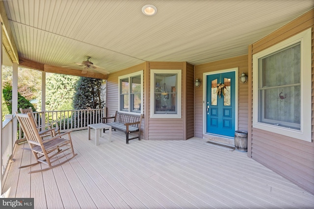 wooden deck with ceiling fan and a porch