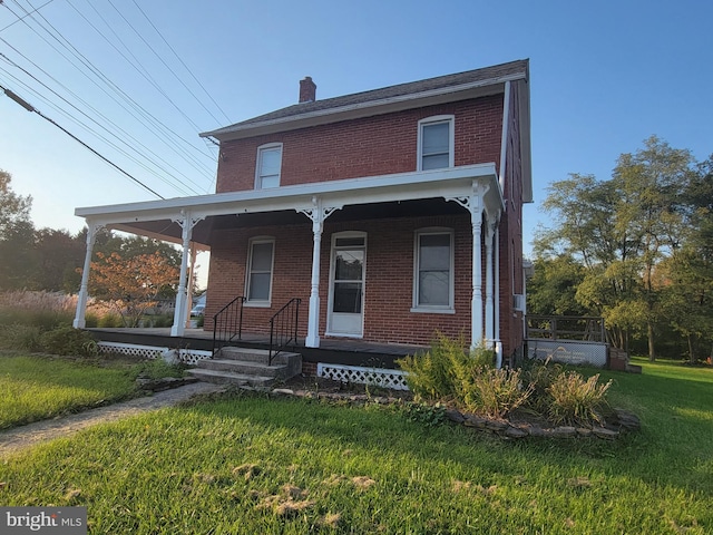 view of front of house featuring a front yard and covered porch