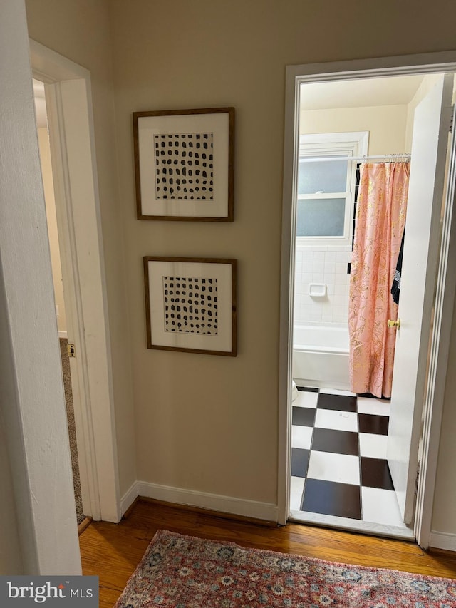 corridor with light hardwood / wood-style floors