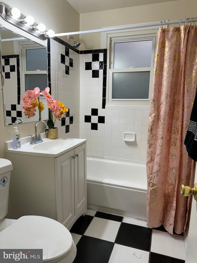 full bathroom with vanity, shower / bath combo, and toilet