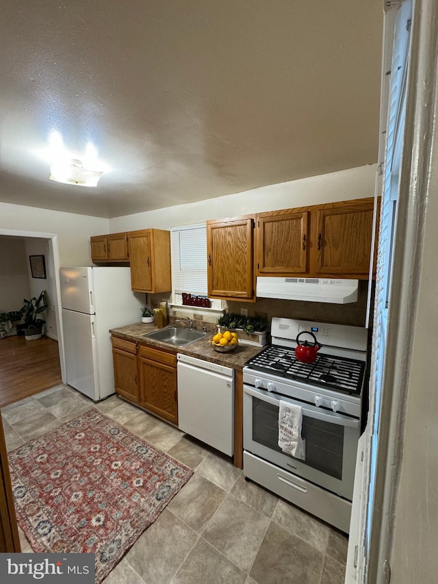 kitchen with sink and white appliances