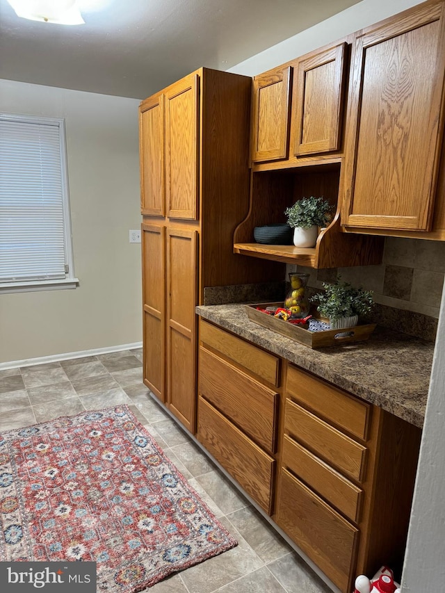 kitchen with dark stone countertops and backsplash