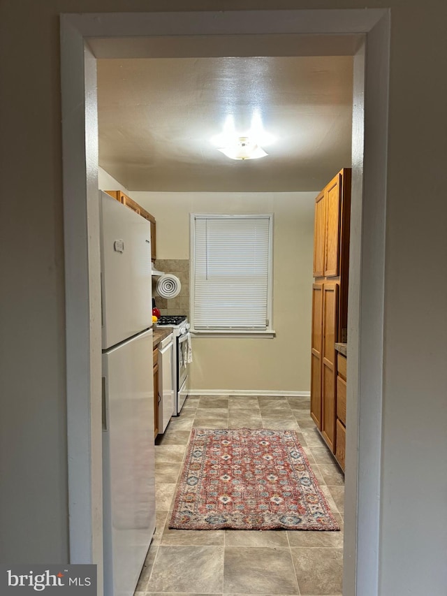 kitchen featuring white appliances and light tile patterned floors