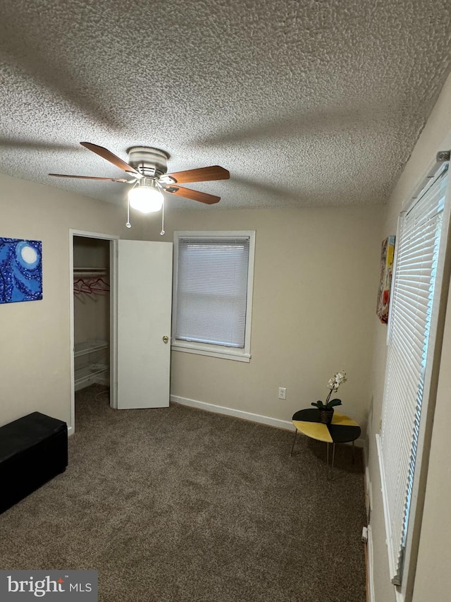 unfurnished bedroom with a textured ceiling, a closet, and ceiling fan