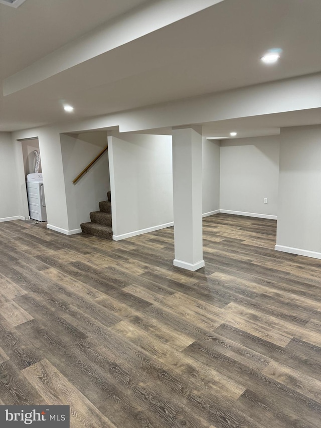 basement featuring washer / dryer and dark hardwood / wood-style floors