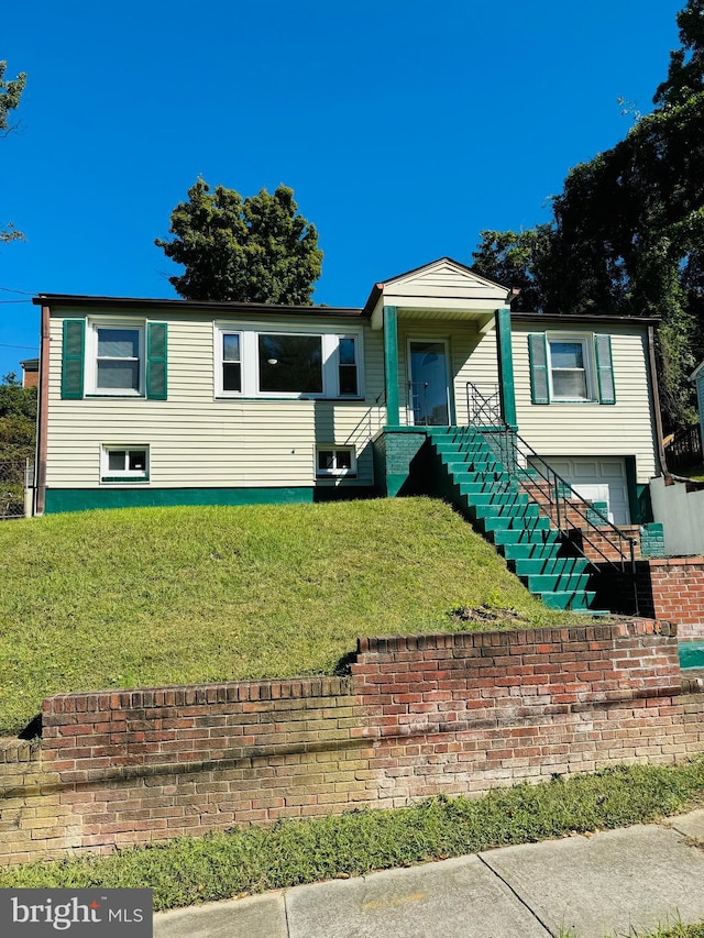 view of front facade with a front lawn and a garage