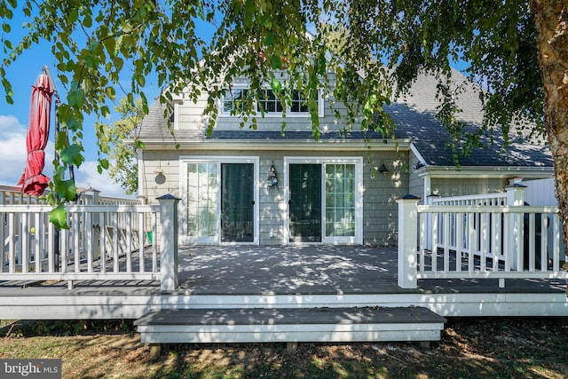 rear view of house featuring a wooden deck