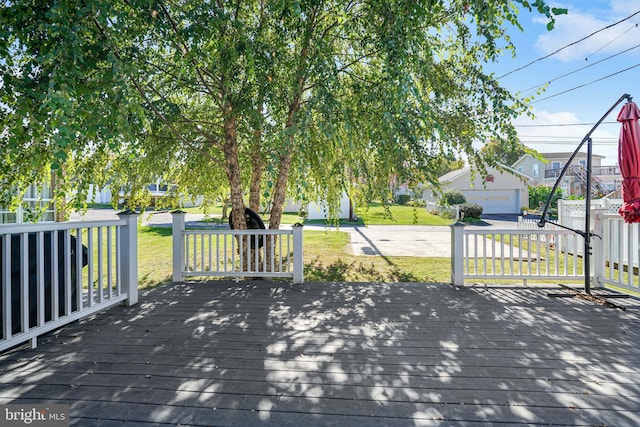 deck featuring a garage and a yard