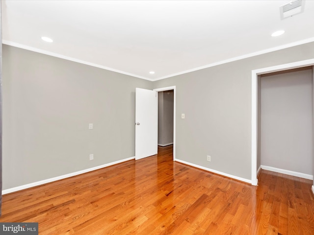 unfurnished bedroom featuring light hardwood / wood-style floors and ornamental molding