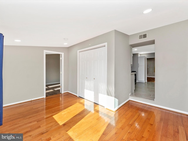 interior space with wood-type flooring and a closet