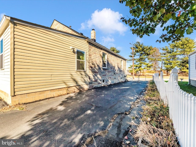 view of property exterior with a patio area