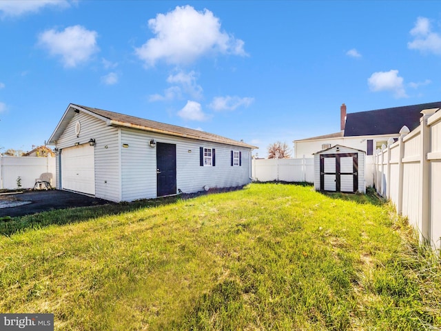 rear view of house with an outbuilding, a garage, and a lawn