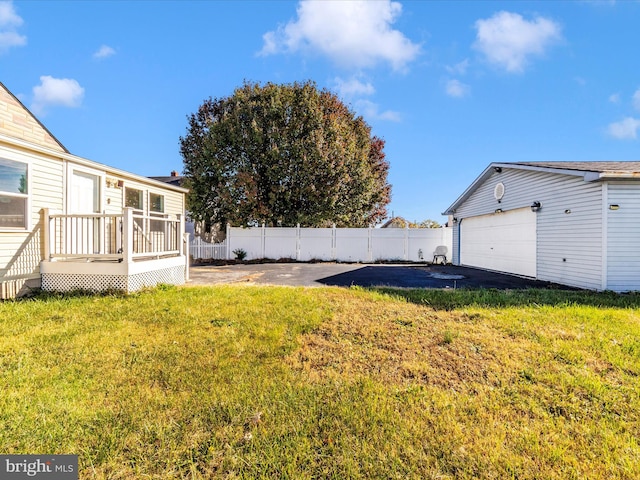 view of yard featuring a garage and a deck