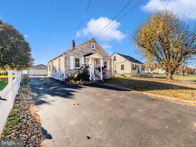 view of front of home with a garage and an outdoor structure