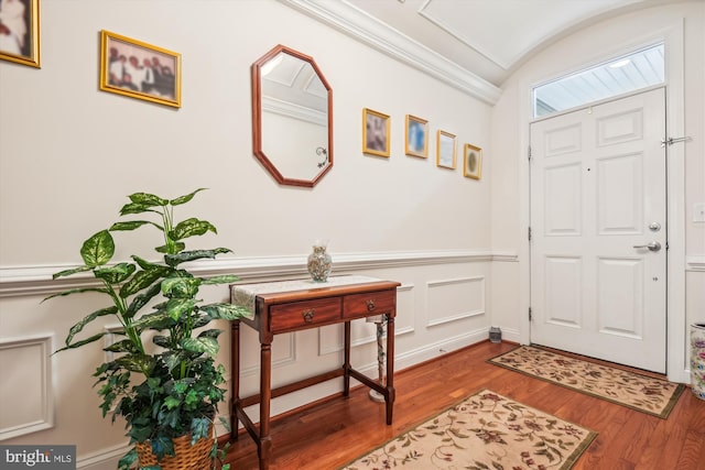 foyer with hardwood / wood-style floors and ornamental molding