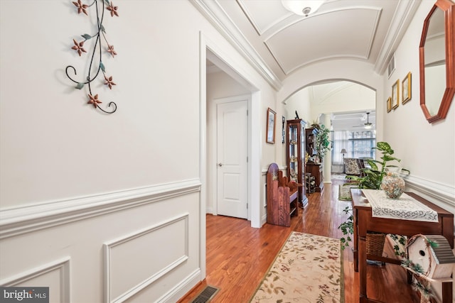 corridor featuring hardwood / wood-style flooring and crown molding