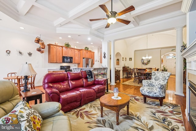 living room featuring coffered ceiling, ceiling fan with notable chandelier, crown molding, light hardwood / wood-style flooring, and beamed ceiling