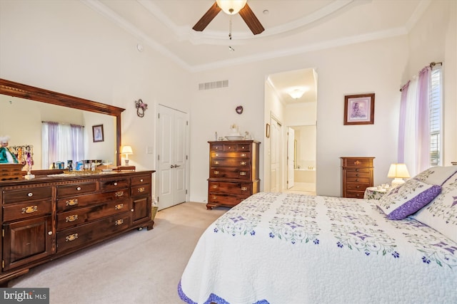 carpeted bedroom with ensuite bath, ceiling fan, multiple windows, and ornamental molding