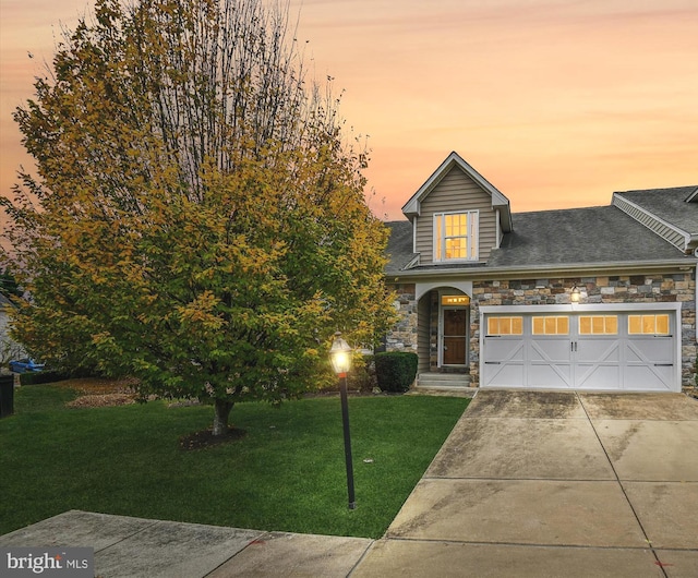 view of front of property featuring a yard and a garage