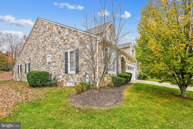 view of home's exterior with a lawn