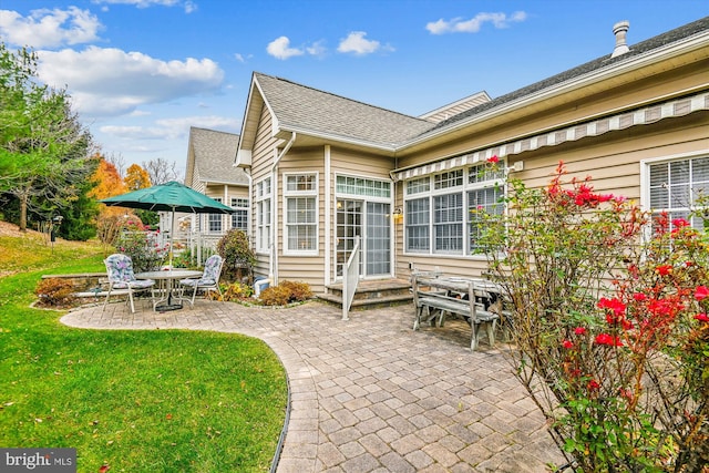 rear view of property with a patio area and a yard