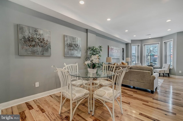 dining space with light hardwood / wood-style flooring