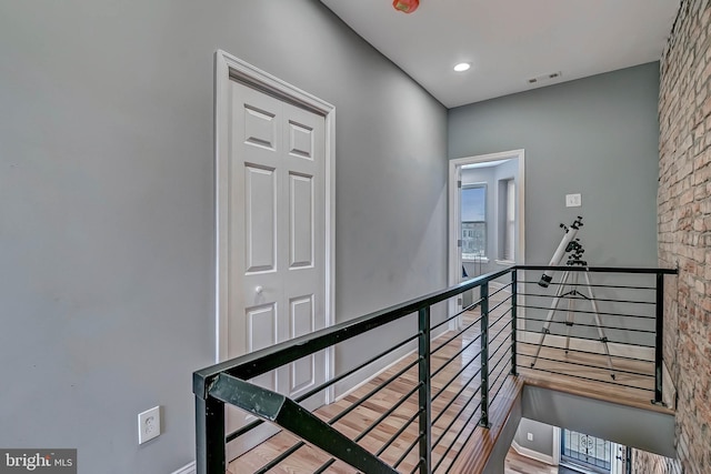 staircase with hardwood / wood-style floors