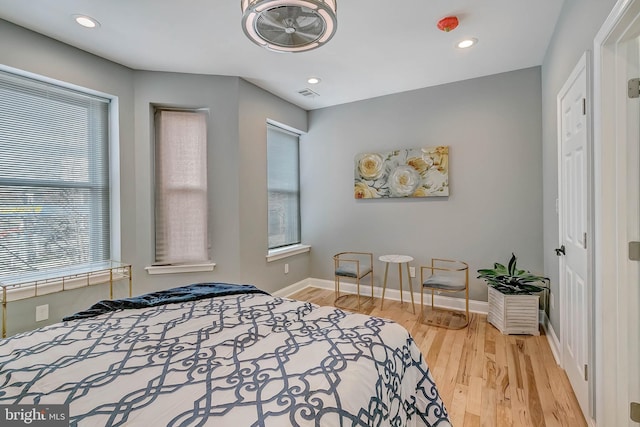 bedroom featuring multiple windows and wood-type flooring