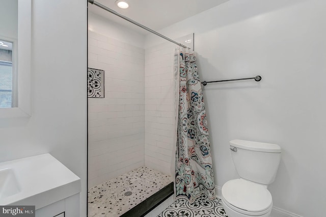 bathroom featuring tile patterned floors, toilet, and walk in shower