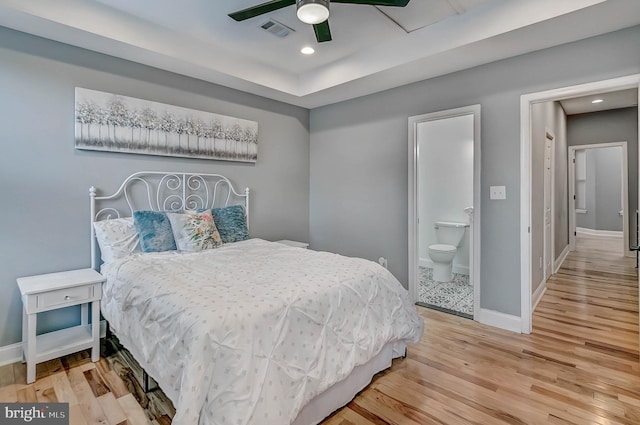 bedroom with connected bathroom, ceiling fan, and wood-type flooring