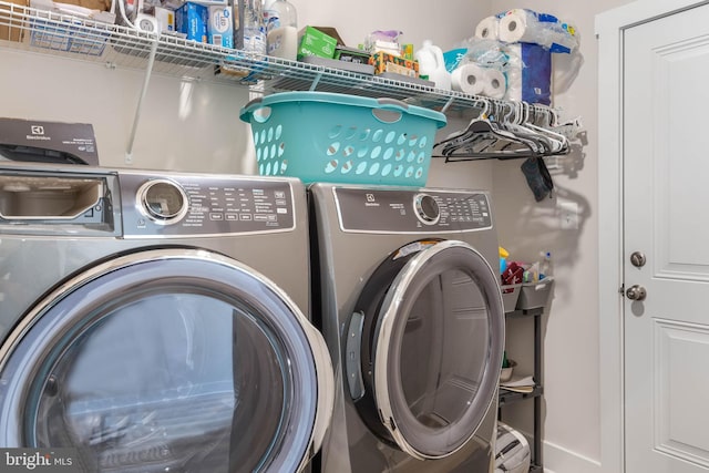 laundry room featuring washing machine and clothes dryer