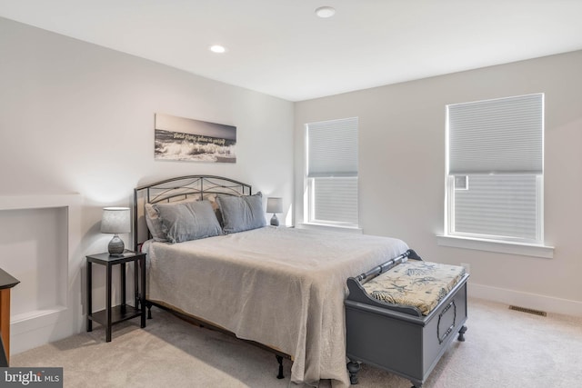 bedroom featuring light colored carpet