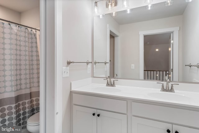 bathroom featuring toilet and vanity