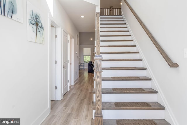 stairs with hardwood / wood-style flooring