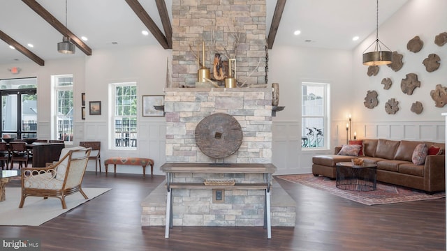 living room featuring a towering ceiling, beamed ceiling, and dark hardwood / wood-style floors