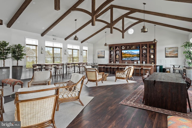 living room featuring a healthy amount of sunlight, hardwood / wood-style flooring, beam ceiling, and high vaulted ceiling