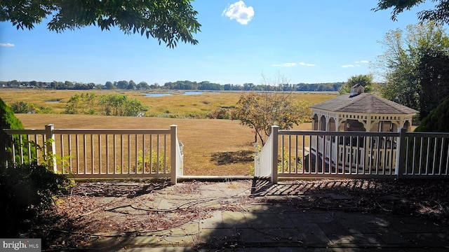 view of gate featuring a rural view and a gazebo