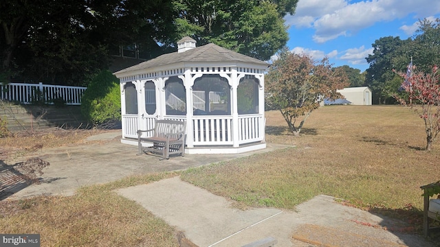 view of outbuilding featuring a gazebo and a lawn