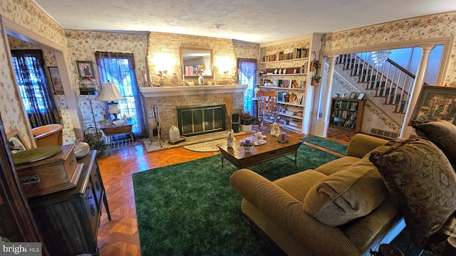 living room featuring parquet floors, ornamental molding, a textured ceiling, and a brick fireplace