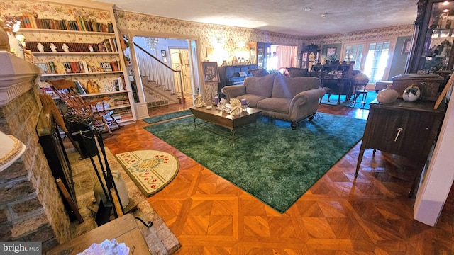 living room featuring parquet flooring and a textured ceiling