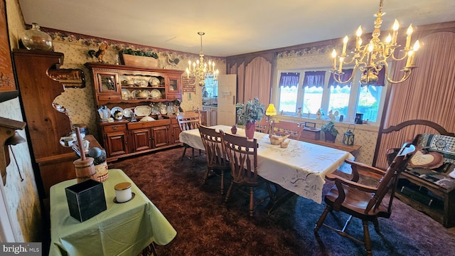 dining area featuring a notable chandelier and dark carpet